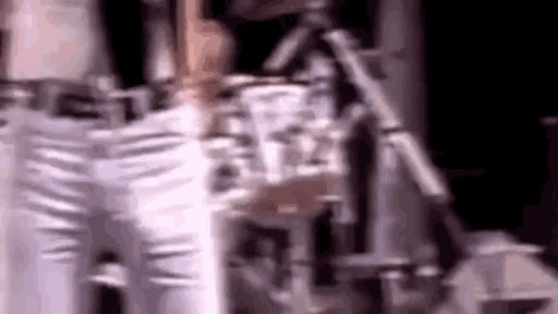 a close up of a person standing next to a machine in a dark room .