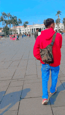 a man wearing a red jacket with big ben written on it