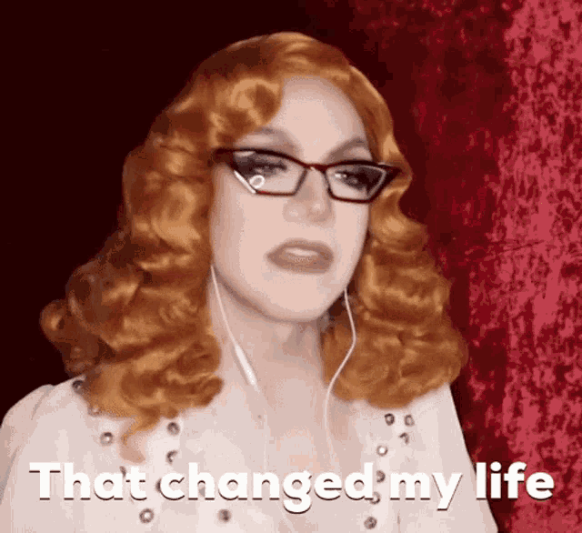 a woman with red hair is wearing glasses and headphones and says that changed my life