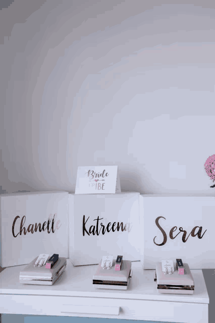 three white boxes with the names chanelle katreena and sera
