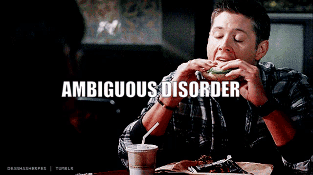 a man in a plaid shirt is eating a sandwich with the words ambiguous disorder behind him