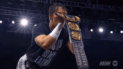 a man wearing a shirt that says ' aew tnt ' on it