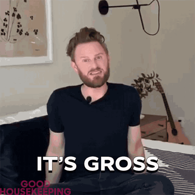 a man sitting on a bed with the words " it 's gross " on the bottom right