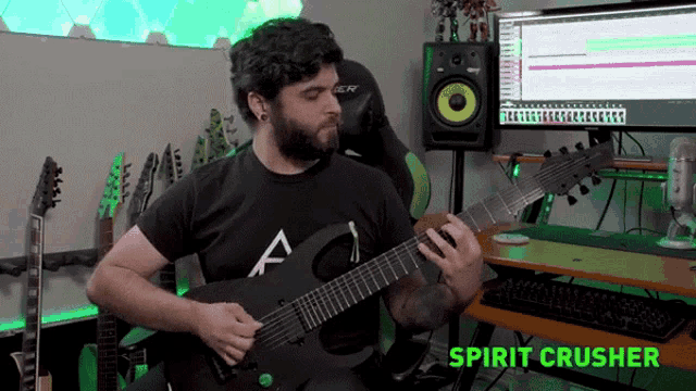 a man playing a guitar in front of a computer with the words spirit crusher on the bottom
