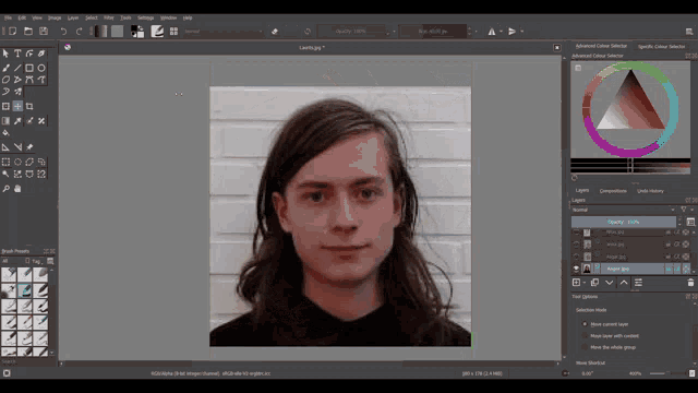 a computer screen shows a man 's face with long hair