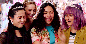 a group of girls with tiaras on their heads are standing next to each other .