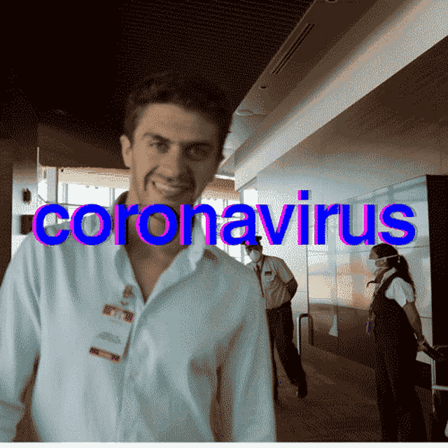 a man is smiling in front of a sign that says " coronavirus "