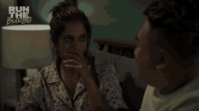 a man and a woman are looking at each other and the words run the burbs are visible