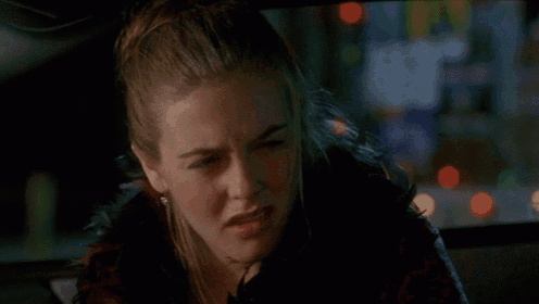 a woman is making a funny face in a car