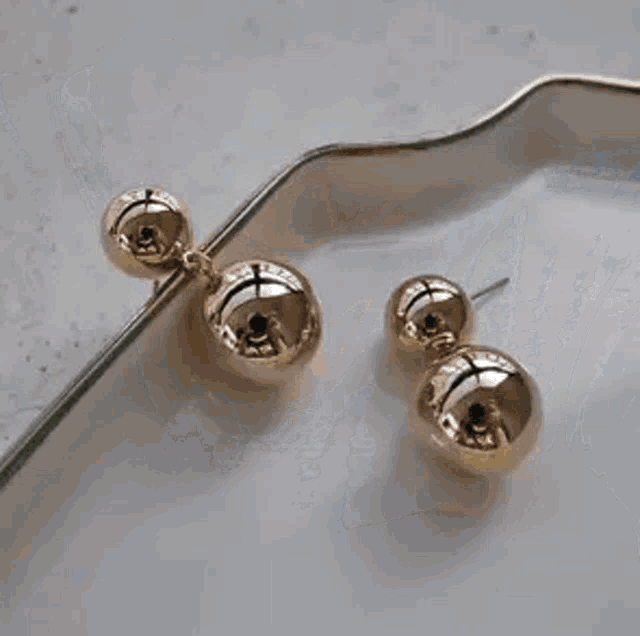 a close up of a woman 's ear with a pearl earring .