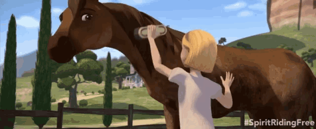 a girl brushes a brown horse with the words spirit riding free on the bottom right