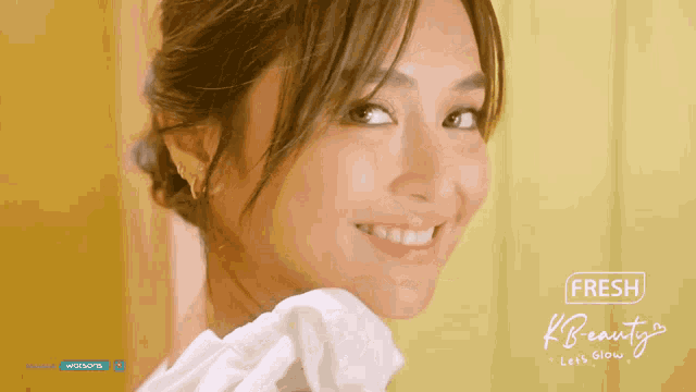 a woman is smiling in front of a fresh k beauty advertisement