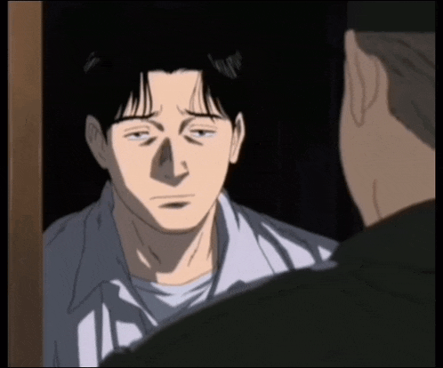 a man in a white shirt is talking to another man