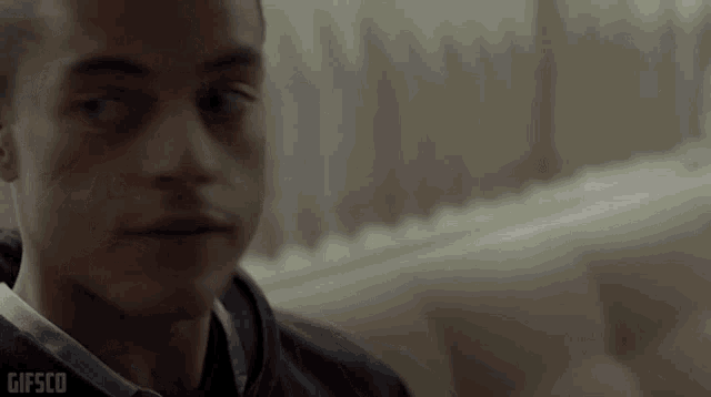 a close up of a man 's face with the words gifsco visible