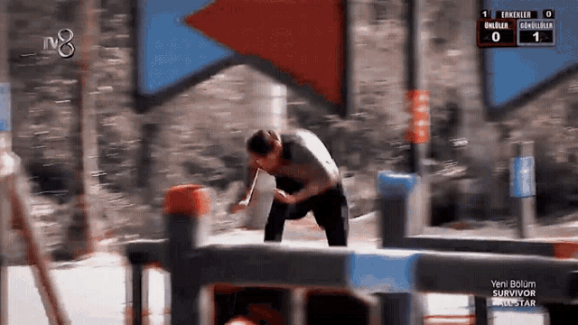 a blurred image of a man jumping over a fence with the number 8 on the bottom