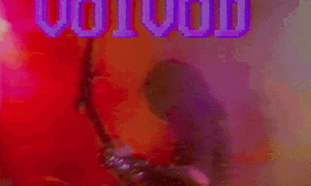 a blurred image of a drum set with the word hollywood written in blue