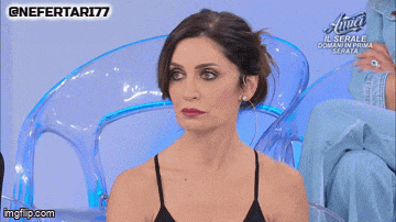 a woman is sitting in a chair with the words te taci written on her face