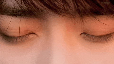 a close up of a person 's eyes with their eyes closed