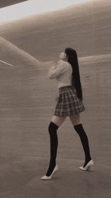 a woman wearing knee high socks and high heels is dancing in the wind