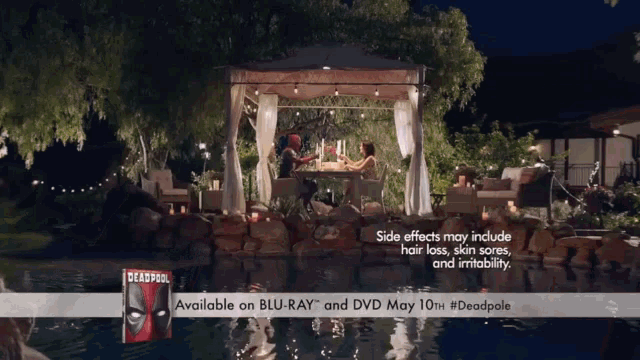 an ad for deadpool shows a couple sitting under a canopy overlooking a pool
