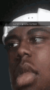 a close up of a man 's face with a snapchat caption that says lemme getcha number .