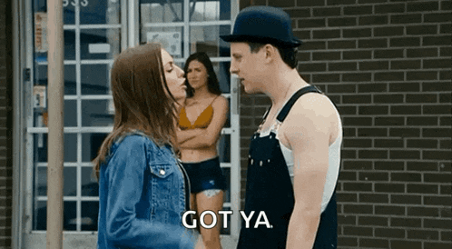 a man and a woman are standing next to each other and the woman is kissing the man 's cheek .