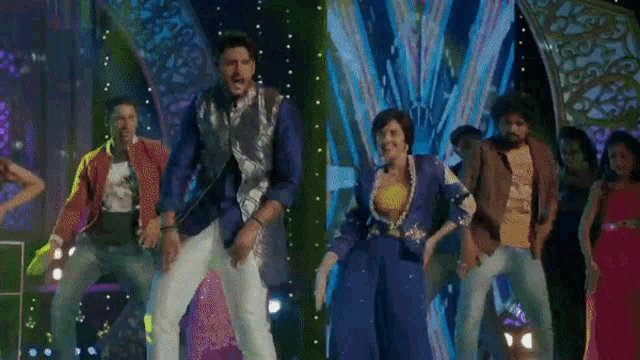 a group of people are dancing on a stage in front of a radio