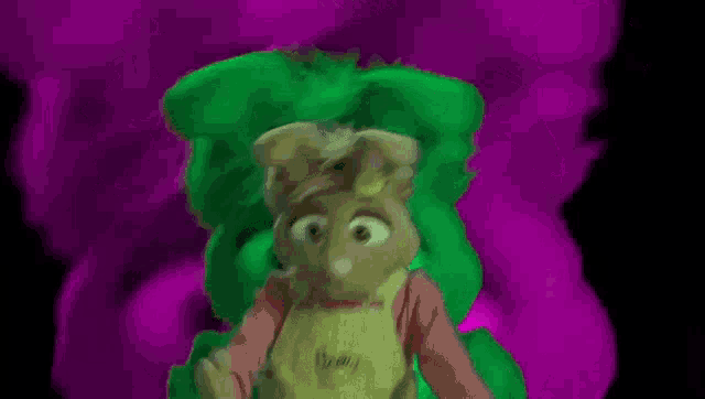 a cartoon character is standing in front of a purple background with a green background .