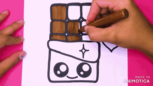 someone is drawing a chocolate bar with a face on it