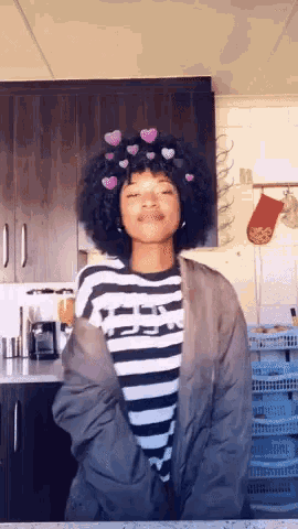 a girl wearing a striped shirt has hearts on her hair
