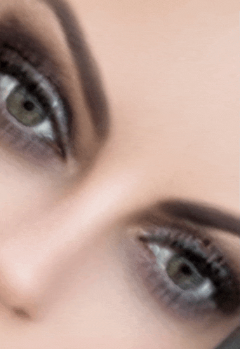 a close up of a woman 's eyes with smokey eye makeup