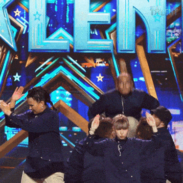 a group of people are dancing in front of a sign that says ' talent '