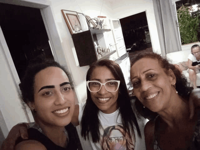 three women posing for a picture with one wearing a t-shirt that says ' i love you ' on it