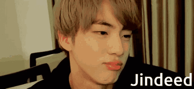a close up of a person 's face with the name jindeed on the bottom right