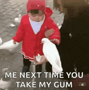 a little girl is feeding a white pigeon while a woman watches .