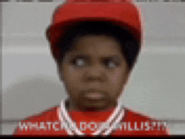 a young boy wearing a red hat and a red shirt with a necklace around his neck .