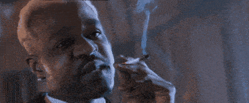 a man smoking a cigarette with the words is it cold in here