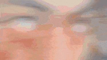 a blurred image of a person 's face with a yellow circle in the middle