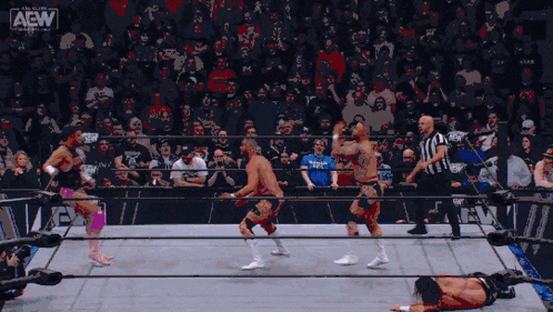 a wrestling match is being shown on a screen that says all elite wrestling