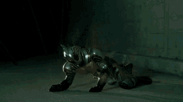 a man is laying on the ground in a tunnel with a group of people standing around him