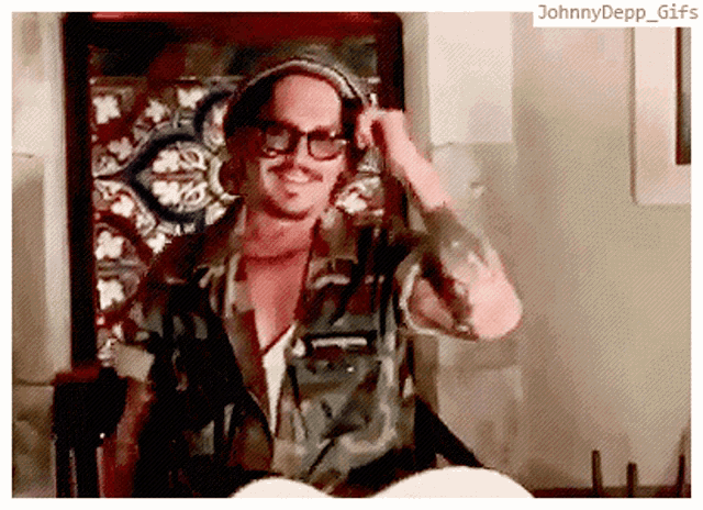 a johnny depp gif with a man in a camouflage shirt