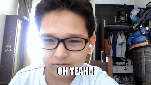 a young boy wearing glasses and earbuds says oh yeah