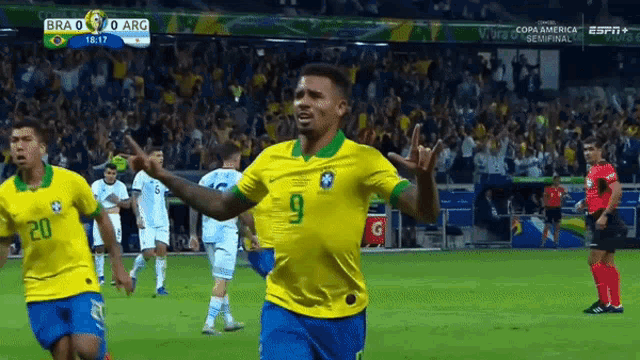 a soccer player with the number 9 on his jersey celebrates