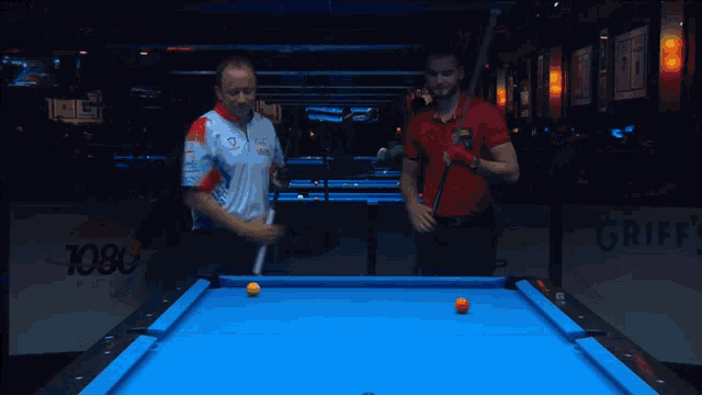 a pool table with a griff 's sign on it