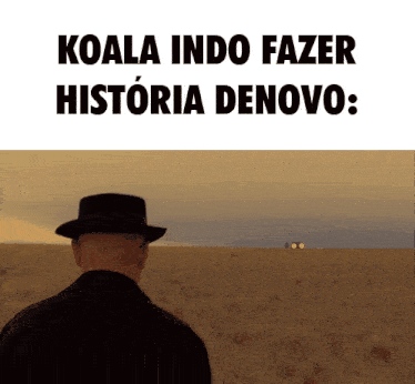 a man in a hat stands in a field with koala indo fazer historia denovo