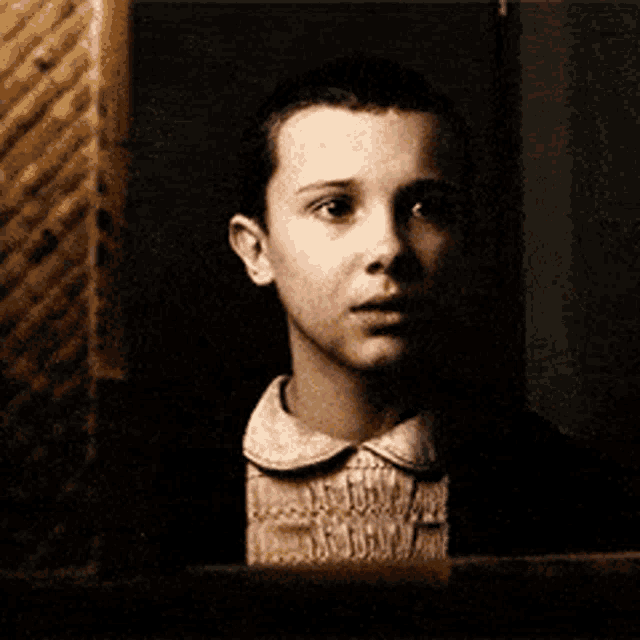 a young girl looking at herself in a mirror