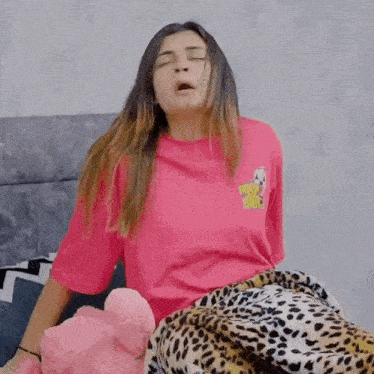 a woman wearing a pink t-shirt that says nasty bitch