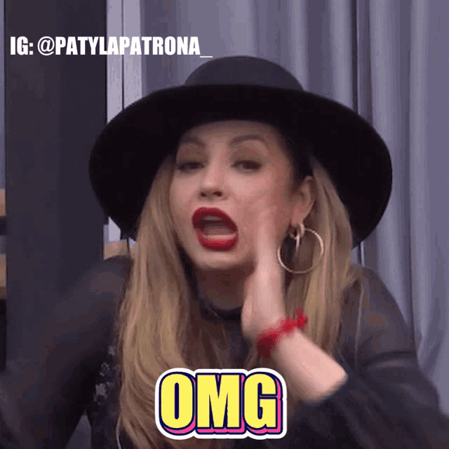 a woman wearing a black hat and red lipstick has the word omg on her face