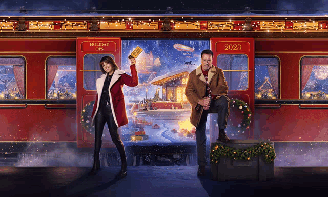 a man and woman are standing in front of a train that says holiday offs