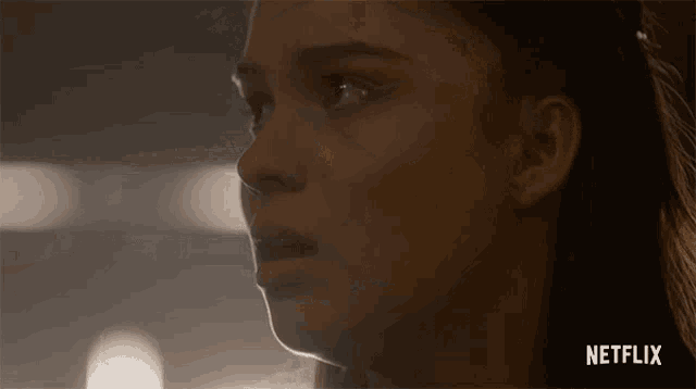 a close up of a woman 's face with netflix written on the bottom right